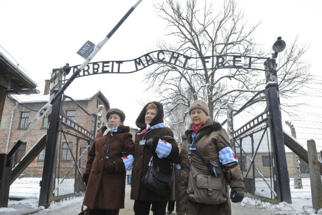 Holocaust survivors walk outside the gate of the of the Auschwitz Nazi death camp in Oswiecim, Poland, on Tuesday. Some 300 Holocaust survivors traveled to Auschwitz for the 70th anniversary of the death camp's liberation by the Soviet Red Army in 1945. Alik Keplicz/AP
