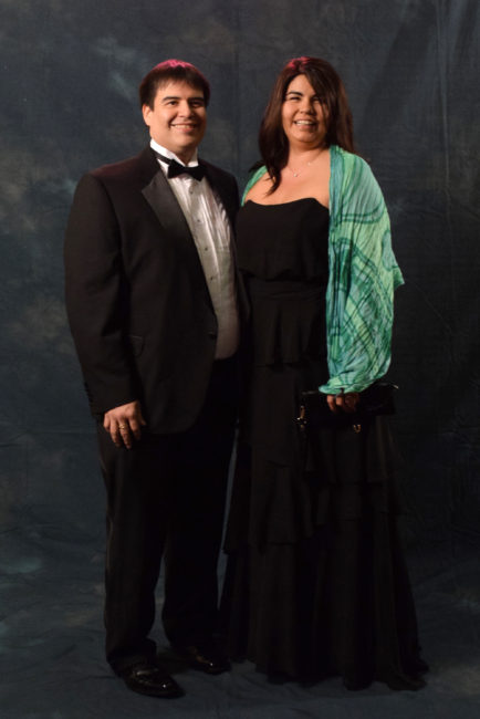 Ken Southerland and Katie Pittman.  Pittman spent Saturday afternoon shopping and decided on an Alfred Angelo dress from Formals Express. The scarf is from Jineit. Southerland, in a Stafford tux, said, "It feels good once in a while to get dressed up and be adults."  (Photo by Skip Gray/KTOO)