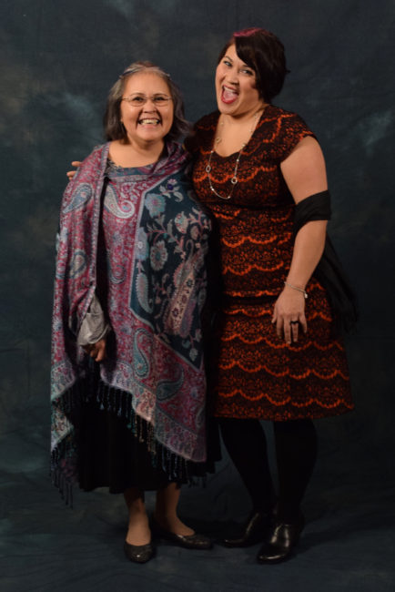 Sandy Demmert and Barbara Blake. Demmert's shawl is from Lisa Davidson's Boutique. Blake decided on her dress from the Alaska General Store because,  “I’ve been into Downton Abbey lately and so I was like, this is kind of like that style."  (Photo by Skip Gray/KTOO) 