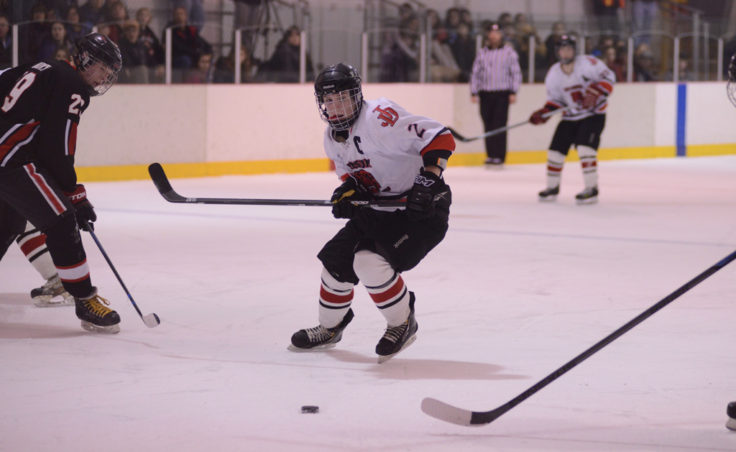 Juneau’s Grant Ainsworth breaks toward a loose puck in Friday’s game versus Houston at Treadwell Ice Arena.