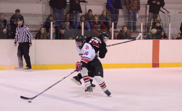 Juneau’s Corey Box eludes Houston’s Reed Humphries in Friday’s game, which Juneau won, 7-3 behind a three-goal performance from Box.