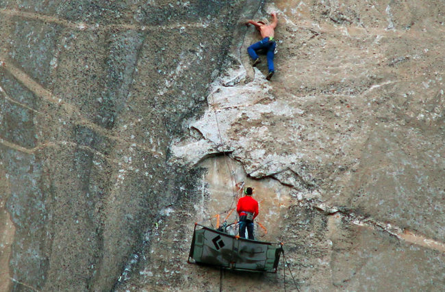 Tommy Caldwell (top) climbs what is known as Pitch 17 and Kevin Jorgeson handles the line as they free-climb the Dawn Wall of Yosemite's El Capitan. Tom Evans/AP