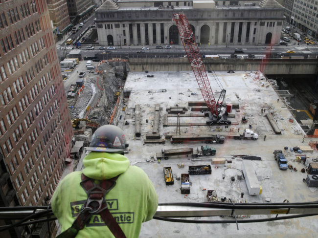 A construction worker looks down on the site of the Manhattan West project, last month in New York. Construction was among the hardest-hit sectors during the worst recession in modern memory. Mark Lennihan/AP