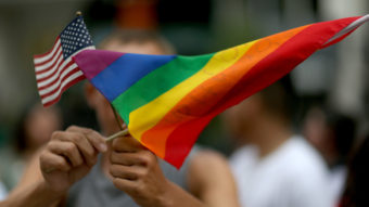 A protester waves an American flag and a rainbow flag in support of gay marriage in Miami in 2014. Secretary of State John Kerry announced Tuesday the appointment of a special envoy for the human rights of LGBT persons. Joe Raedle/Getty Images