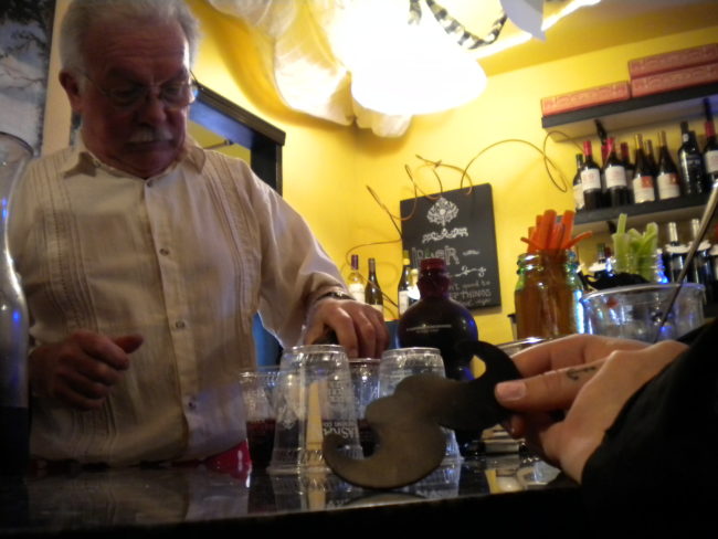 Butch Laughlin serving wine at Paradise Cafe on Saturday. (Kevin Reagan/ KTOO)