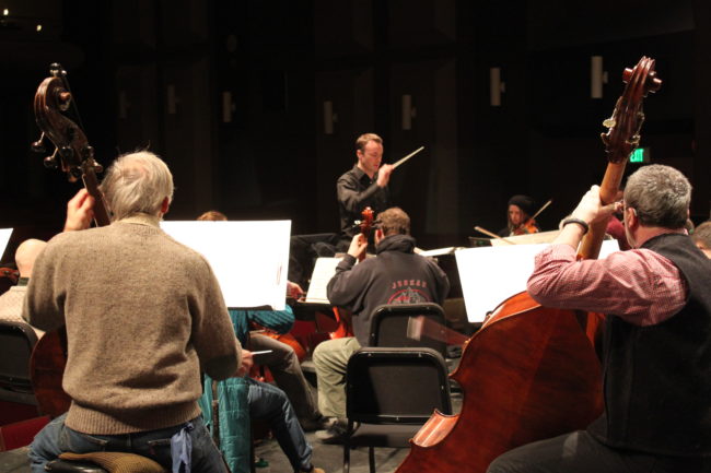 Wesley Schulz leads the Juneau Symphony during rehearsal Tuesday night. (Photo by Lisa Phu/KTOO)