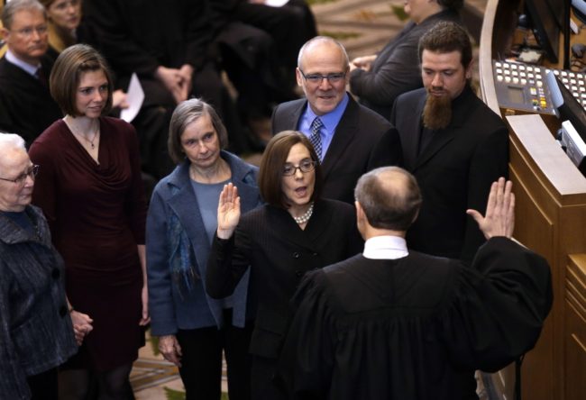 Oregon Secretary of State Kate Brown is sworn in as Oregon Governor by Oregon Chief Justice Thomas A. Balmer in Salem, Ore., on Wednesday. Don Ryan/AP