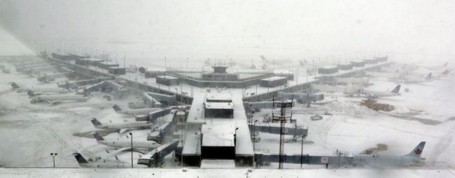 Airplanes stand in the snow at O'Hare International Airport on Sunday in Chicago. The city received 19 inches of snow from a storm that is now in the Northeast. Nam Y. Huh/AP