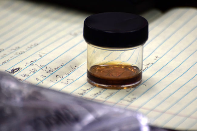 A sample of marijuana hash oil, sits on the testifier’s desk in an Alaska House Judiciary Committee hearing, March 6, 2015. The committee had asked law enforcement officials to give them a “show and tell” about the drugs and associated paraphernalia. (Photo by Skip Gray/360 North)