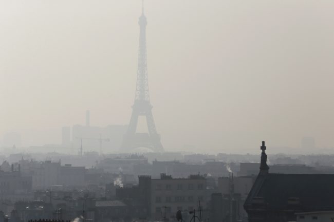 A photo taken on Feb. 12 shows the Eiffel Tower through thick smog. (Photo by Patrick Kovarik/AFP/Getty Images)