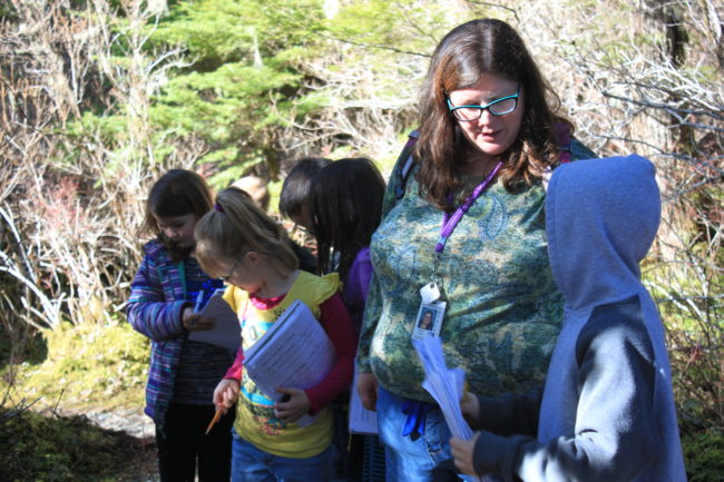 Allie Smith talks to one of her second grade students during a nature walk Tuesday afternoon. (Photo by Lisa Phu/KTOO)