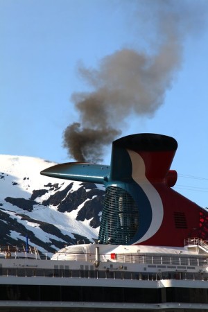 Smoke pours out of the smokestack of the Carnival Spirit cruise ship as it fires up its engines. (Courtesy Ground Truth Trekking)
