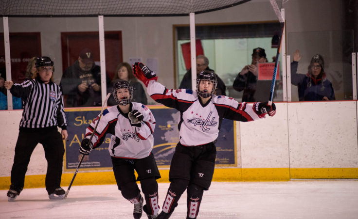 Jaime Hort and Culley Corrigan celebrate a goal versus the Mat-Su team in an opening round game at Treadwell Ice Arena. (Photo by Steve Quinn)