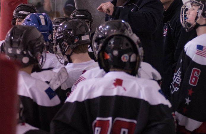 Juneau head coach Ian Leary discusses overtime strategy with this team in a Sunday semifinal game versus Fairbanks. (Photo by Steve Quinn)