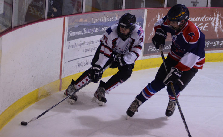 Owen Squires battles a Mat-Su opponent in an opening round game at Treadwell Ice Arena. (Photo by Steve Quinn)