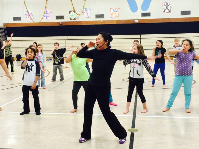 Ricci Adan works with students in the JAMM school musical program. (Photo courtesy Karen Allen)