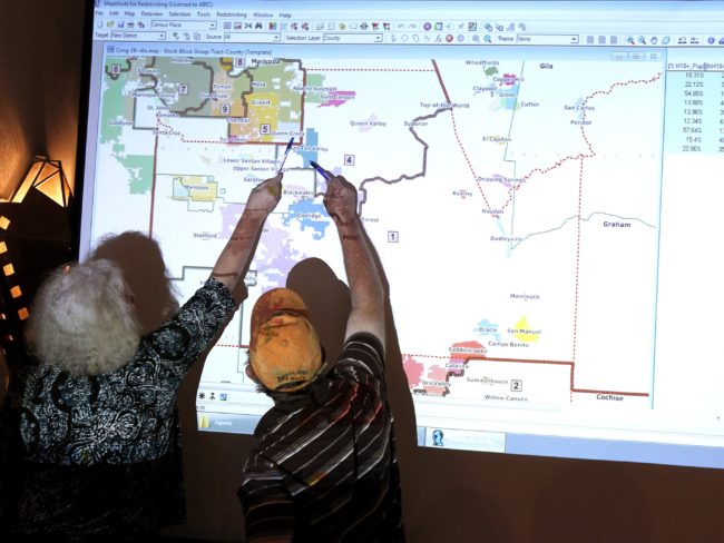 Arizona commission attorney Mary O'Grady (left) and Stephen Miller, a city council member, point to a possible redistricted map in 2011. Ross D. Franklin/AP