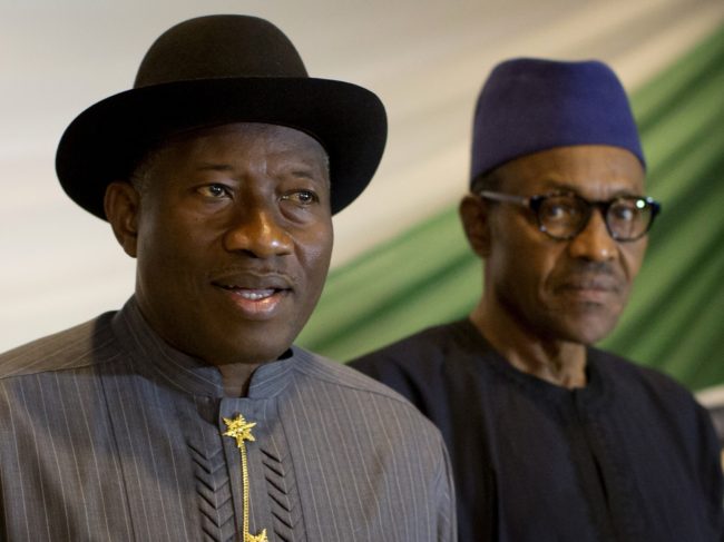 Nigeria's President Goodluck Jonathan, left, and opposition candidate Gen. Muhammadu Buhari, right, prepare to sign a renewal of their pledge to hold peaceful "free, fair, and credible" elections, at a hotel in the capital Abuja, Nigeria, on Thursday. (Photo by Ben Curtis/AP)