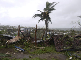 In this March 14, 2015, photo provided by World Vision, debris is strewn around a lone tree in Port Vila, Vanuatu, after Cyclone Pam ripped through the tiny South Pacific archipelago. (Photo courtesy AP)