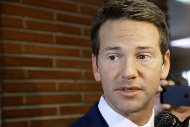 Rep. Aaron Schock, R-Ill., talks to reporters on Feb. 6. The congressman, whose spending habits have come under heavy scrutiny, resigned Tuesday effective March 31. Seth Perlman/AP