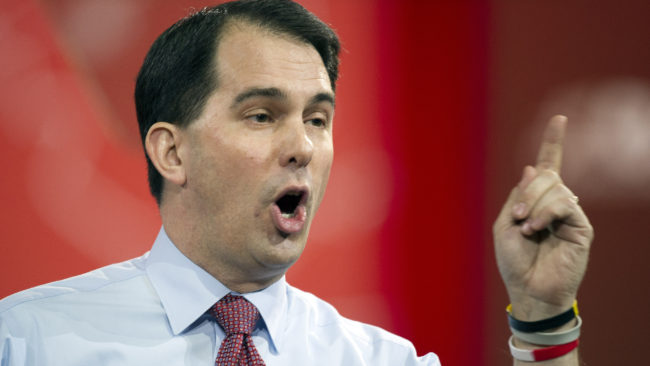 Wisconsin Gov. Scott Walker became a Republican political star by taking on his state's public employee unions. This week he signed a bill that would weaken private-sector unions. Cliff Owen/AP