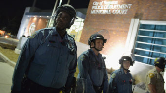 Police in riot gear respond to demonstrators blocking traffic during a protest outside the Ferguson Police Department in Missouri Wednesday. As the protests were ending, someone fired at the police -- wounding two officers.(Michael B. Thomas/Getty Images)