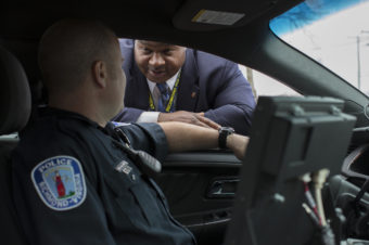 Detective Mark Williams (right) speaks with an officer in Richmond, Va. A decade ago, amid a surge in violent crime, Richmond police were identifying relatively few murder suspects. So the police department refocused its efforts to bring up its "clearance rate." (Photo by Alex Matzke for NPR)