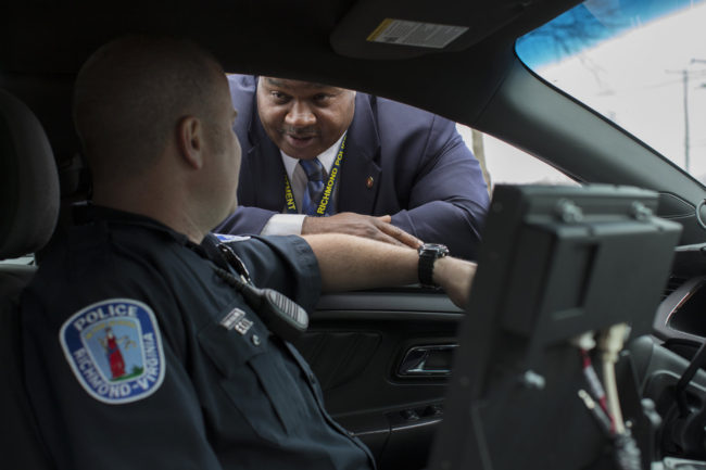 Detective Mark Williams (right) speaks with an officer in Richmond, Va. A decade ago, amid a surge in violent crime, Richmond police were identifying relatively few murder suspects. So the police department refocused its efforts to bring up its "clearance rate." Alex Matzke for NPR