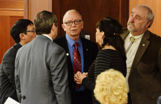 Leaders of opposing caucuses of the Alaska House of Representatives talk just before the final vote on Senate Bill 64, April 2, 2015. The bill would put a 5-year freeze on the state's reimbursement of school capital debt. From left to right: Rep. Scott Kawasaki, D-Fairbanks; Rep. Chris Tuck, D-Anchorage; Rep. Steve Thompson, R-Fairbanks; Rep. Charisse Millett, R-Anchorage; Rep. Craig Johnson, R-Anchorage. (Photo by Skip Gray/360 North)