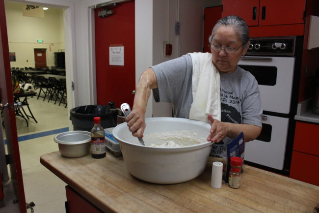 Siouxbee Lindoff mixes the kulich dough by hand (Elizabeth Jenkins/KTOO) 