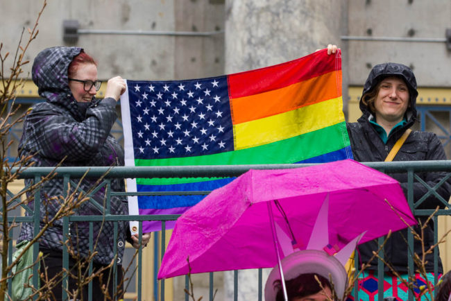 Rally participants carried flags and wore Statue of Liberty headpieces. (Photo by David Purdy?KTOO)