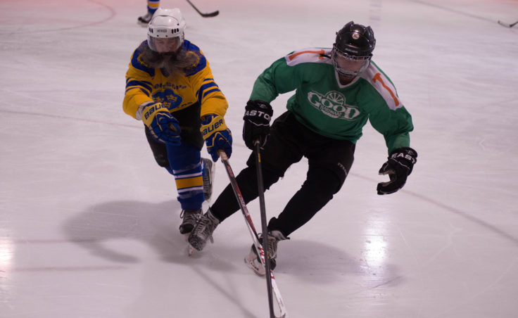 Svensson Boatworks Matt Reece (left) and Good Hardware’s Hans Moser race toward a loose in playoff action during a Juneau Adult Hockey Association contest. (Photo by Steve Quinn)