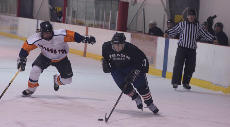 Thane Chris Siddon (right) stays a few strides ahead of Island Pub’s Austin Osterhout as he races to the net in playoff action during a Juneau Adult Hockey Association contest. (Photo by Steve Quinn)