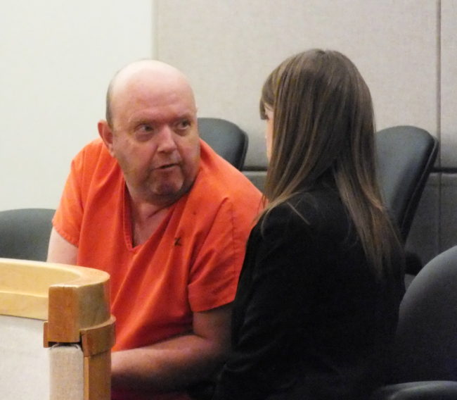 Larry Randolph Powell speaks with an attorney in Juneau District Court on April 21 following his arrest on charges related to the robbery of the valley branch of the Northrim Bank.