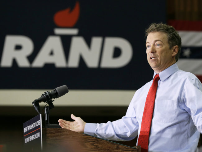 Paul at the University of Iowa last week, with his campaign logo in the background. (Photo by Charlie Neibergall/AP)