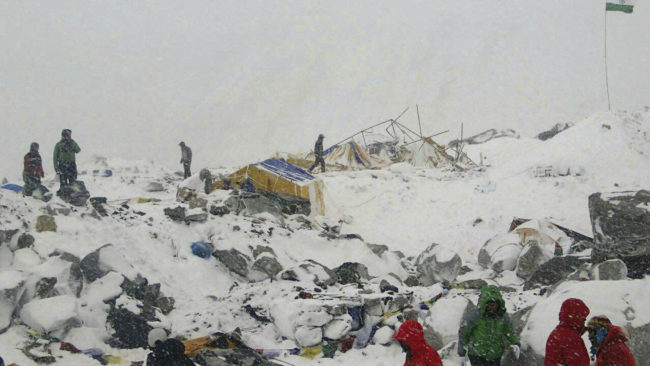 People approach the scene after an avalanche triggered by a massive earthquake swept across Everest Base Camp, Nepal on Saturday. At least 17 people have been killed on the mountain. (Photo by Azim Afif/AP)