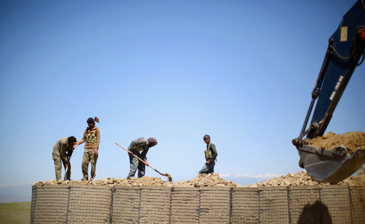Workers set up a local police checkpoint in Nangahar Province, just a few miles from the Pakistan border. Many insurgent fighters slip over the mountains from Pakistan. That's why this checkpoint is being set up. (Photo by David Gilkey/NPR)