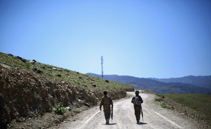 Afghan Army soldiers head up a road in Nangahar Province, where Taliban fighters are attacking a police checkpoint under construction. (Photo by David Gilkey/NPR)