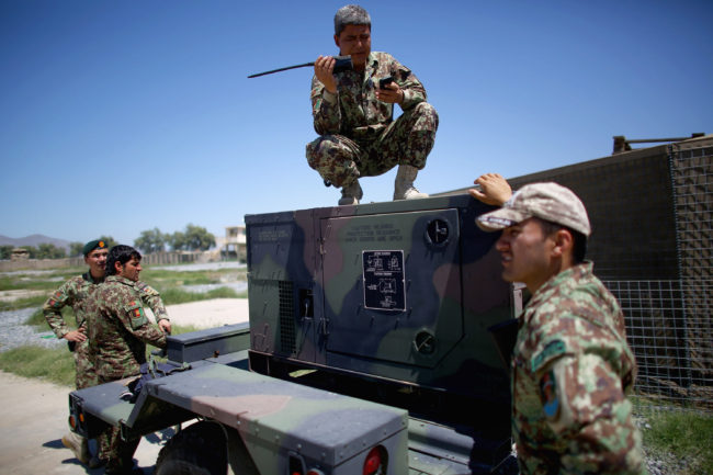 Afghan army battalion commander, Lt. Col. Ghani Khel, talks with his soldiers after successful strike on a Taliban truck and rocket launcher. (Photo by David Gilkey/NPR)