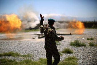 An artillery gun fires a round at Taliban fighters in the hills of Nangahar Province. (Photo by David Gilkey/NPR)