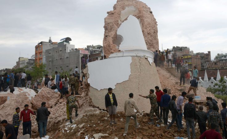 Nepalese rescue members and onlookers gather at the collapsed Dharahara Tower in Kathmandu. (Photo by Prakash Mathema/AFP/Getty Images)