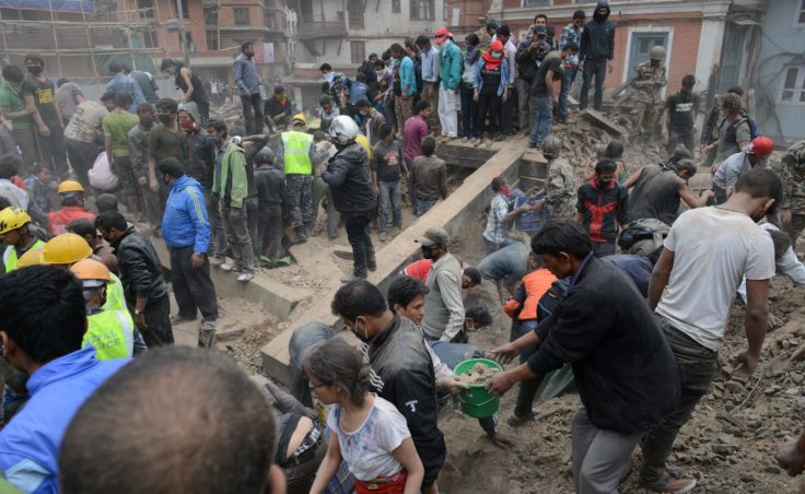 People clear rubble in Kathmandu's Durbar Square, a UNESCO World Heritage Site that was severely damaged by the earthquake (Photo by Prakash Mathema /AFP/Getty Images)