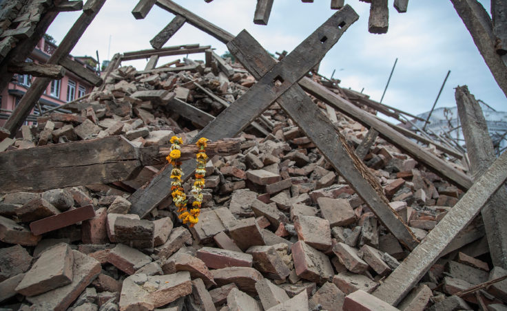 Flowers are left by survivors on top of debris from a collapsed building at Basantapur Durbar Square following the earthquake. (Photo by Omar Havana/Getty Images)