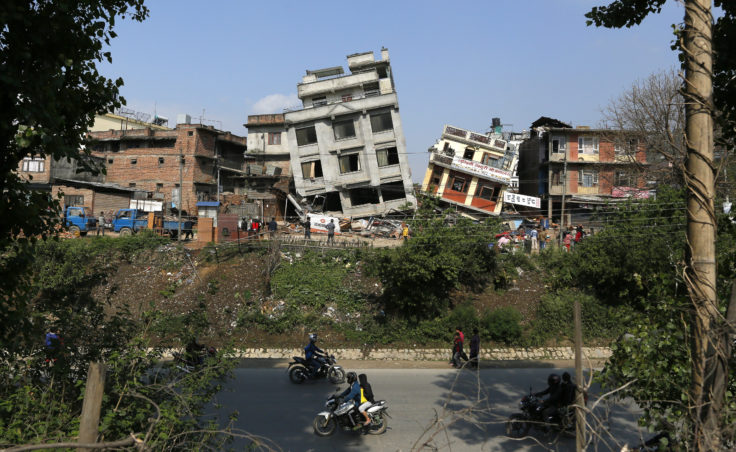 Damaged buildings tilt precariously in Kathmandu. The magnitude-7.8 earthquake shook Nepal's capital and the densely populated Kathmandu Valley, causing extensive damage. (Photo by Wally Santana/AP)