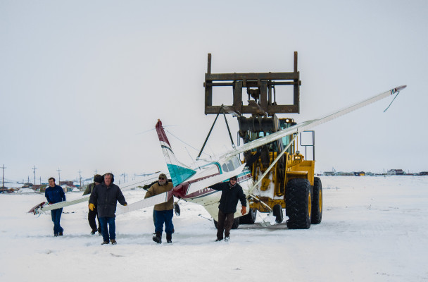 A team of responders transporting the damaged Cessna 185 after it landed at Nome’s City Field on Thursday afternoon. (Photo: Francesca Fenzi/KNOM)