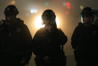 Oakland police officers, wearing body cameras, form a line during demonstrations against recent incidents of alleged police brutality nationwide. (Photo by Elijah Nouvelage/Getty Images)