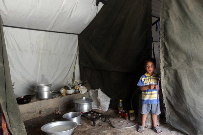 An Iraqi boy, whose family fled Ramadi after it was seized by the self-declared Islamic State, is now living in a tent camp for displaced families near the capital Baghdad. Many civilians fled the city and government forces are now attempting to regroup. Ahmad Al-Rubaye/AFP/Getty Images