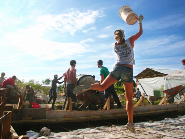 In Haiti after the earthquake, volunteers with All Hands toss buckets from the cement mixer back to the sand piles for a quick refill. (Photo courtesy of All Hands Volunteers)