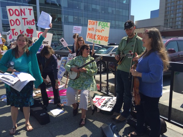 Fiddlers and protesters gather outside the LIO in downtown Anchorage. (Photo by Anne Hillman/KSKA)