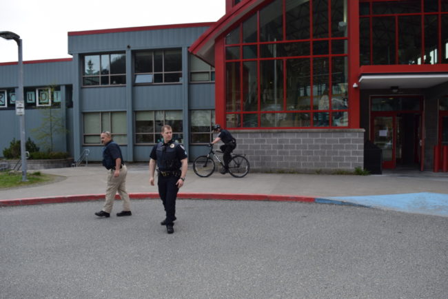 JPD officers make sure Juneau-Douglas High School is secure after a threatening call prompted heightened security at the school for the second time in eight days. Left-right: Detective Nick Garza, Sgt. Krag Campbell and officer Brent Bartlett on the bike. (Photo by Casey Kelly/KTOO)